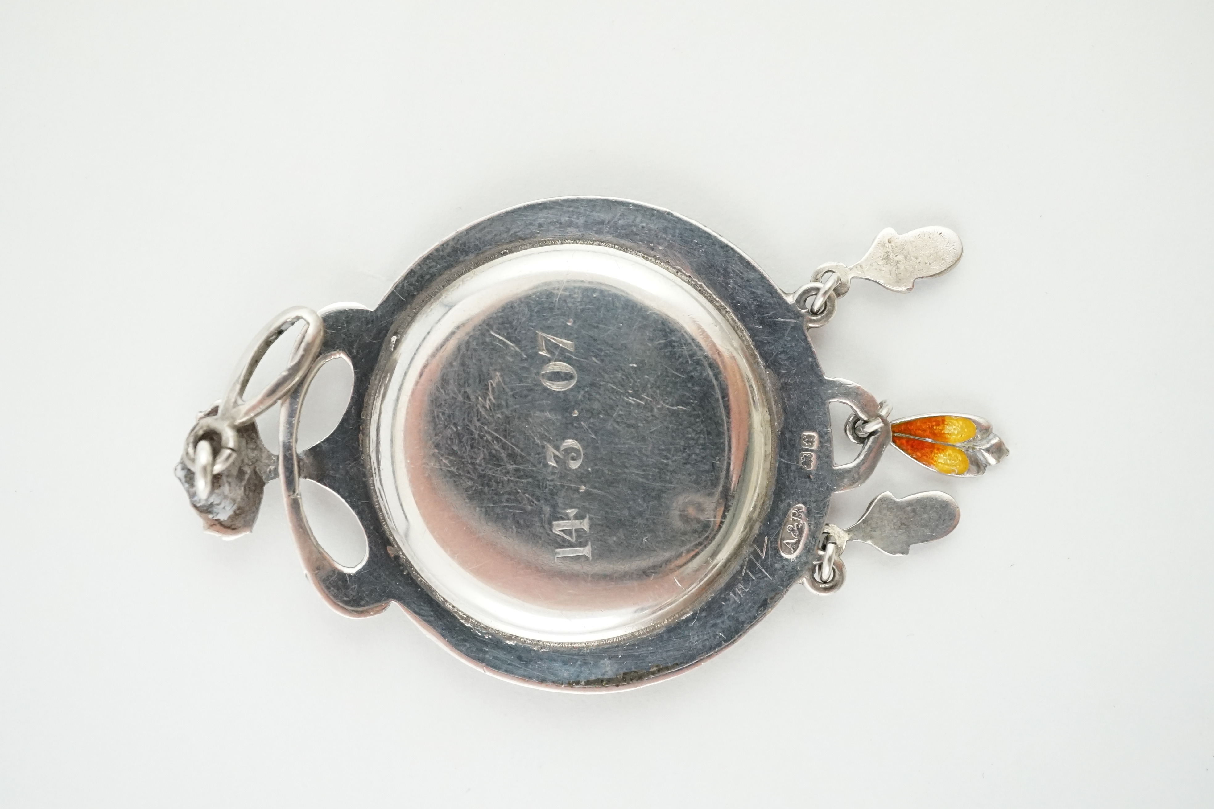 An Edwardian Art Nouveau silver, enamelled and turquoise inset bark textured silver portrait pendant, Abrahall & Bint, Birmingham, 1906, 58mm. Condition - poor to fair